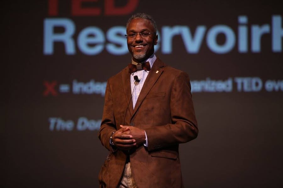 James smiling on stage at TEDxReservoirHigh
